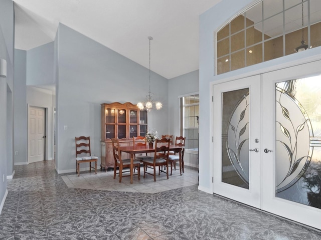 dining room featuring a chandelier, french doors, high vaulted ceiling, and baseboards