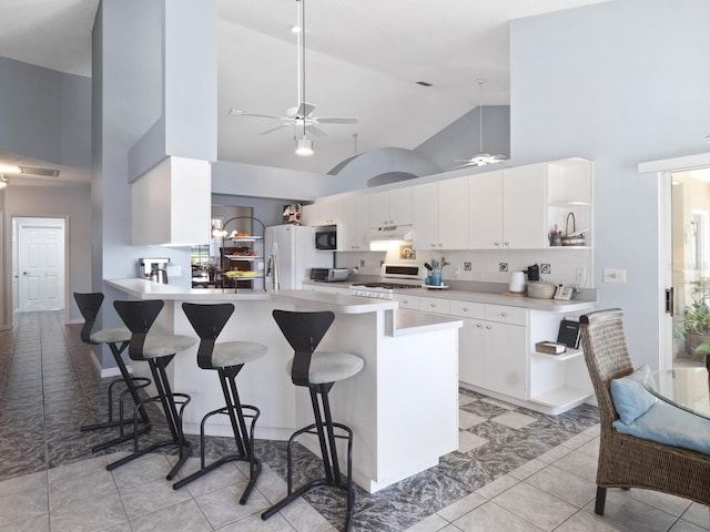 kitchen with open shelves, white appliances, a peninsula, and under cabinet range hood