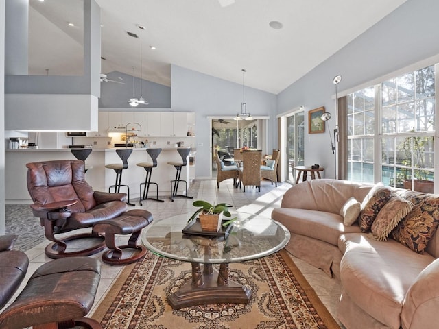 living room featuring light tile patterned floors, high vaulted ceiling, and ceiling fan