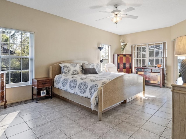 bedroom featuring light tile patterned flooring and ceiling fan