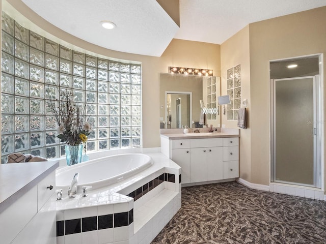 bathroom with vanity, a shower stall, and a garden tub