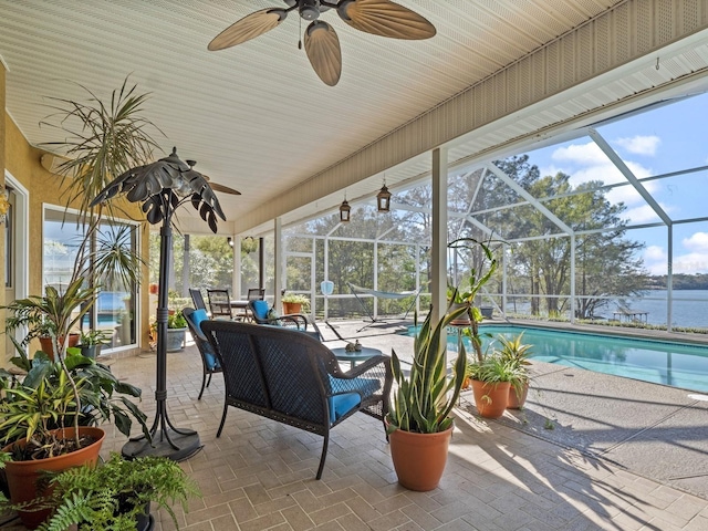 sunroom featuring a pool and a ceiling fan