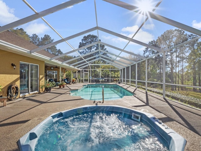 pool featuring a lanai, an outdoor hot tub, and a patio