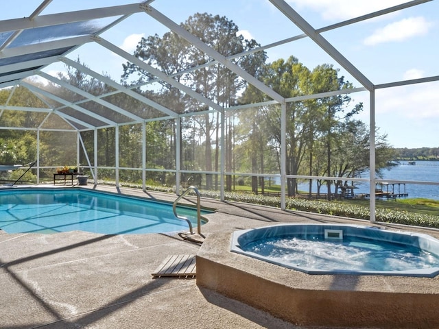 pool with glass enclosure, a patio, an outdoor hot tub, and a water view