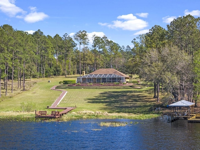 property view of water featuring a view of trees and a boat dock