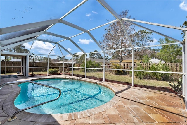 view of swimming pool featuring a lanai, a patio area, and a fenced backyard