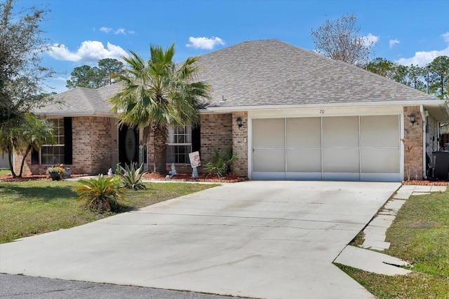 single story home with an attached garage, brick siding, driveway, and roof with shingles