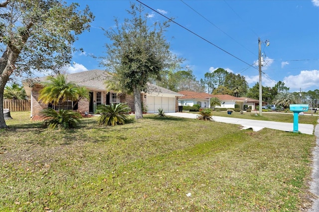 view of front of house with an attached garage, concrete driveway, and a front yard