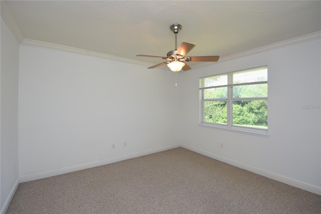 empty room featuring baseboards, ceiling fan, light colored carpet, ornamental molding, and a textured ceiling