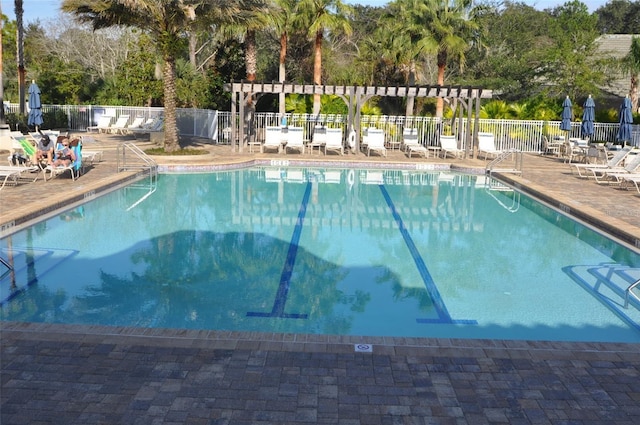 pool featuring a patio and fence