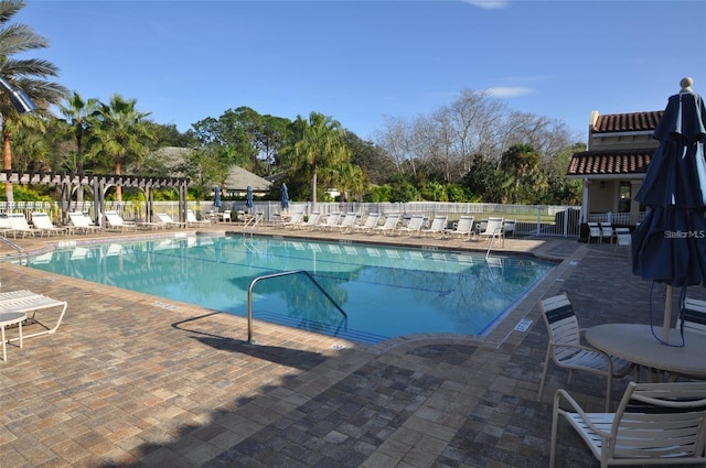 community pool featuring a pergola, a patio, and fence