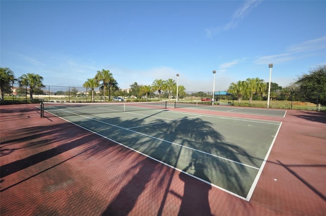 view of tennis court featuring fence