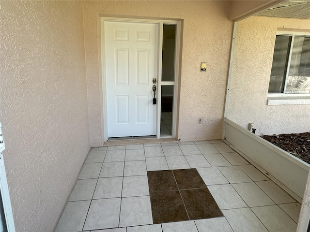 entrance to property with stucco siding