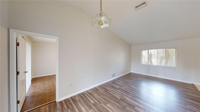 spare room with visible vents, baseboards, and wood finished floors