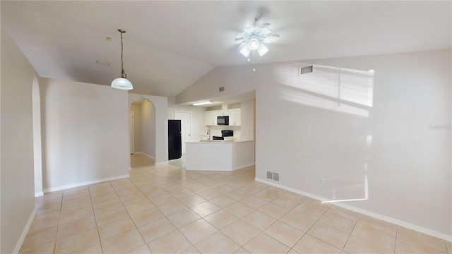 unfurnished living room with visible vents, arched walkways, light tile patterned flooring, and a ceiling fan
