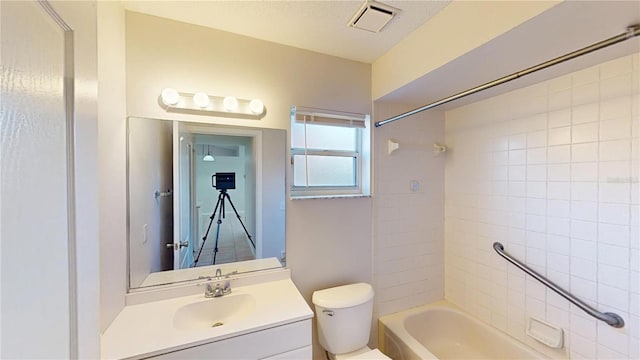 full bathroom featuring visible vents, toilet, vanity, and shower / bathtub combination