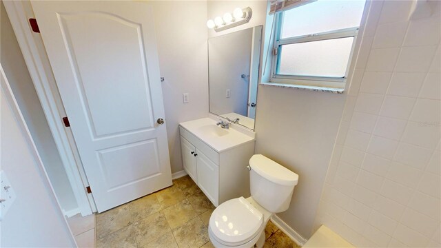bathroom with toilet and vanity