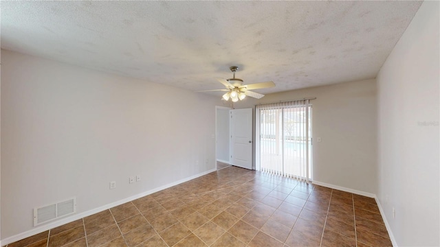 spare room with visible vents, a textured ceiling, baseboards, and ceiling fan