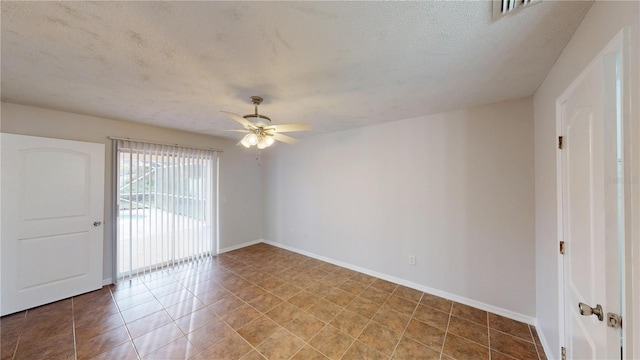 unfurnished room with tile patterned flooring, visible vents, baseboards, ceiling fan, and a textured ceiling