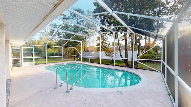 view of swimming pool featuring a fenced backyard, a shed, a fenced in pool, a lanai, and a patio area