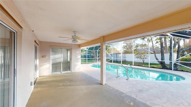 view of pool featuring a lanai, a patio, ceiling fan, and fence