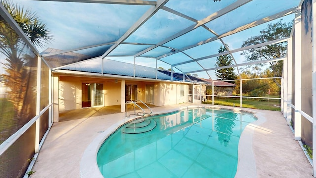 outdoor pool with a lanai and a patio area