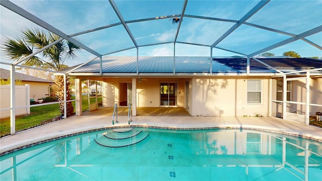 pool featuring a patio area, a lanai, a ceiling fan, and fence