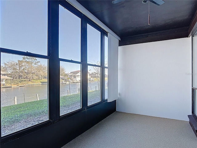 carpeted spare room featuring a water view