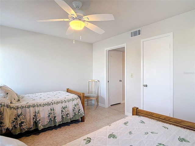 bedroom with visible vents, baseboards, light tile patterned flooring, and a ceiling fan