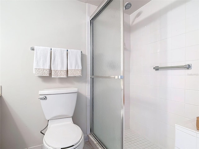 bathroom with a stall shower and toilet