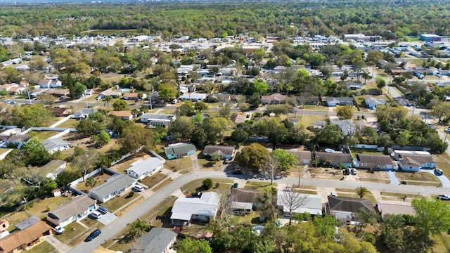 birds eye view of property featuring a forest view and a residential view