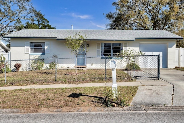 ranch-style house with concrete block siding, driveway, roof with shingles, an attached garage, and a fenced front yard