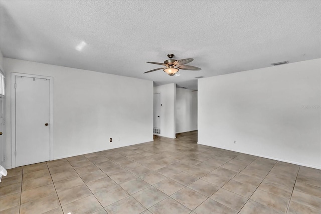 spare room with visible vents, a textured ceiling, and a ceiling fan