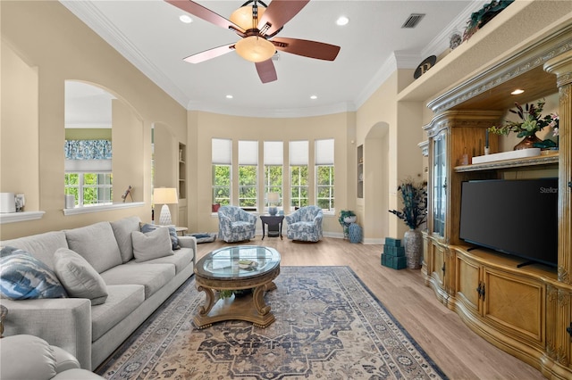 living room featuring visible vents, ceiling fan, recessed lighting, arched walkways, and light wood-style flooring