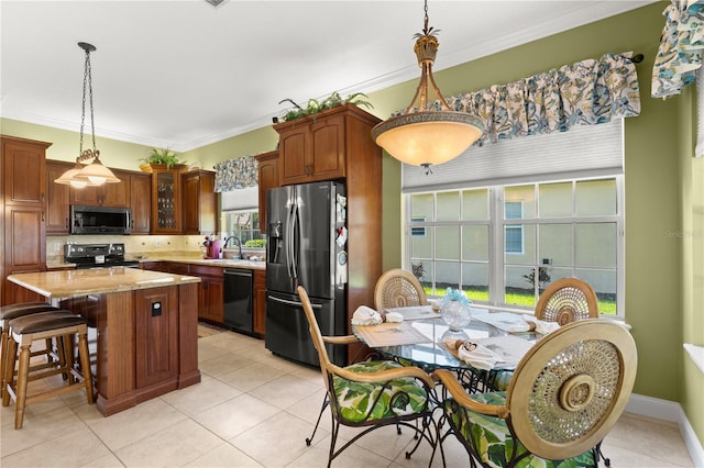 kitchen with appliances with stainless steel finishes, ornamental molding, a sink, and tasteful backsplash