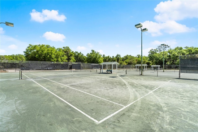view of tennis court with fence