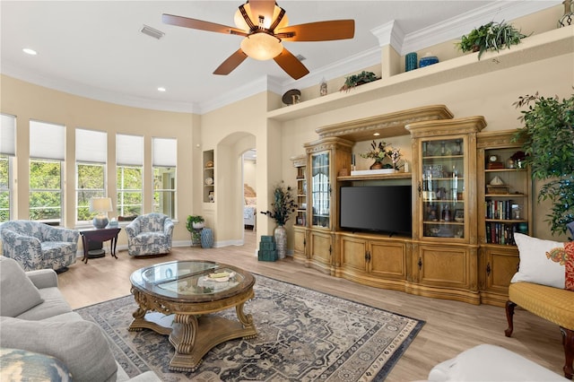 living room featuring visible vents, a ceiling fan, recessed lighting, light wood-type flooring, and arched walkways
