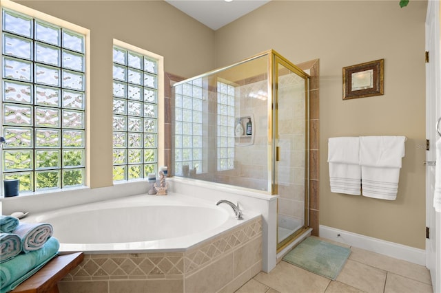 full bath featuring a shower stall, a wealth of natural light, tile patterned flooring, and a garden tub