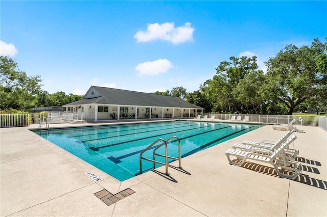 community pool featuring a patio and fence