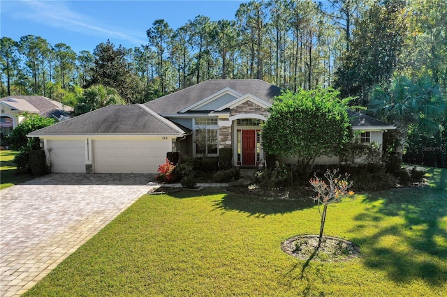 view of front of property featuring stucco siding, driveway, a front lawn, an attached garage, and a shingled roof