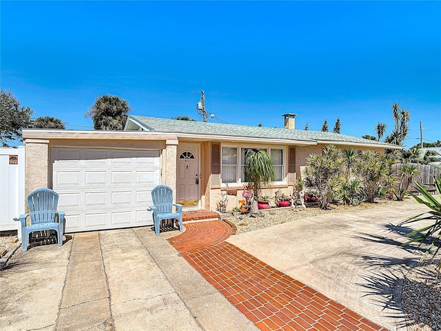 ranch-style house featuring stucco siding, fence, concrete driveway, a garage, and a chimney