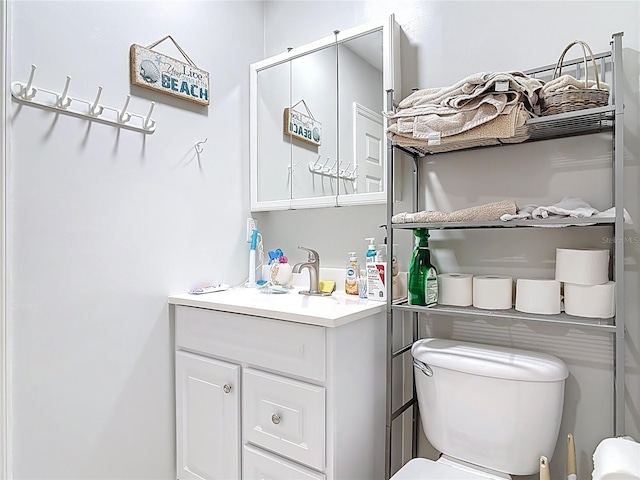 half bath featuring toilet and vanity