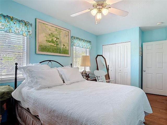 bedroom featuring ceiling fan, a closet, and wood finished floors