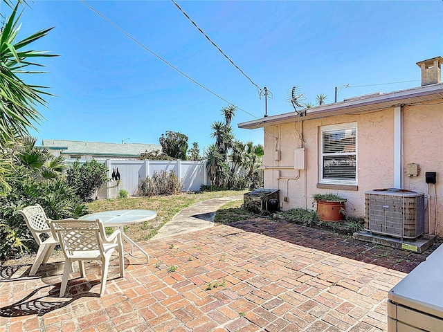 view of patio / terrace featuring central AC unit and fence