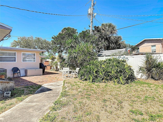 view of yard with central AC unit, a patio, and fence