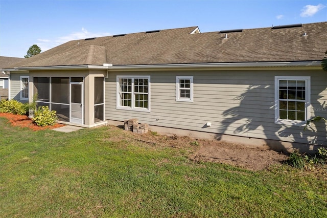 309 Crystal Lake Dr, Saint Augustine, FL 32084 - rear view of house featuring a yard, a sunroom, and a shingled roof