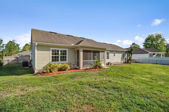 309 Crystal Lake Dr, Saint Augustine, FL 32084 - rear view of property featuring a sunroom, a lawn, a fenced backyard, and central AC