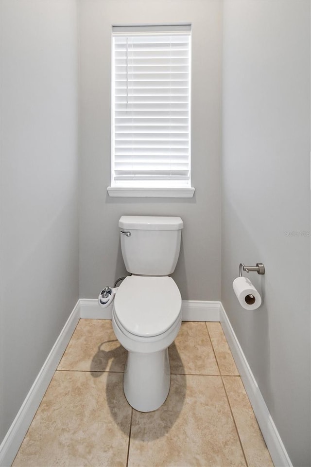 309 Crystal Lake Dr, Saint Augustine, FL 32084 - bathroom with baseboards, toilet, plenty of natural light, and tile patterned flooring