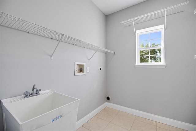 309 Crystal Lake Dr, Saint Augustine, FL 32084 - clothes washing area with baseboards, laundry area, a sink, washer hookup, and electric dryer hookup