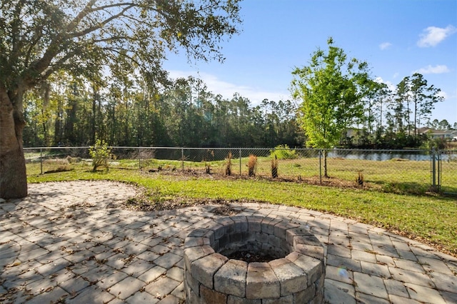 309 Crystal Lake Dr, Saint Augustine, FL 32084 - view of patio featuring a water view, a fire pit, and fence private yard